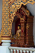 Chiang Mai - The Wat Phra Singh temple. The Viharn Luang (main prayer hall). Buddha image in the center of the back side portico. 